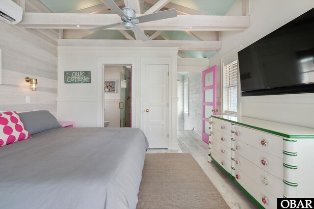 5118 N Virginia Dare Trl Lot 7, Kitty Hawk, NC 27949 - bedroom featuring an AC wall unit, wood finished floors, and ensuite bathroom