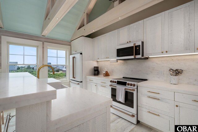 5118 N Virginia Dare Trl Lot 7, Kitty Hawk, NC 27949 - kitchen with white appliances, tasteful backsplash, white cabinetry, light countertops, and a desk