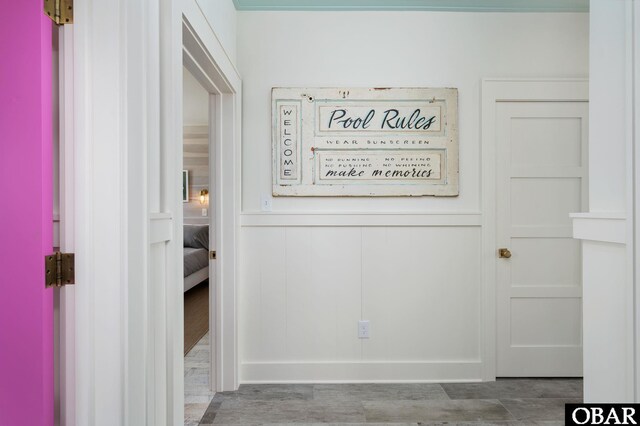 5118 N Virginia Dare Trl Lot 7, Kitty Hawk, NC 27949 - hallway featuring a decorative wall, wood finished floors, and a wainscoted wall