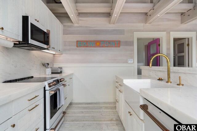 5118 N Virginia Dare Trl Lot 7, Kitty Hawk, NC 27949 - kitchen with white appliances, beam ceiling, light wood-style flooring, white cabinetry, and decorative backsplash