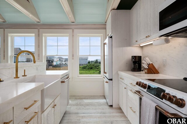 5118 N Virginia Dare Trl Lot 7, Kitty Hawk, NC 27949 - kitchen with white appliances, light wood-type flooring, light countertops, and white cabinets