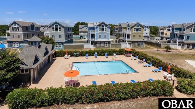 pool featuring a residential view, fence, and a patio