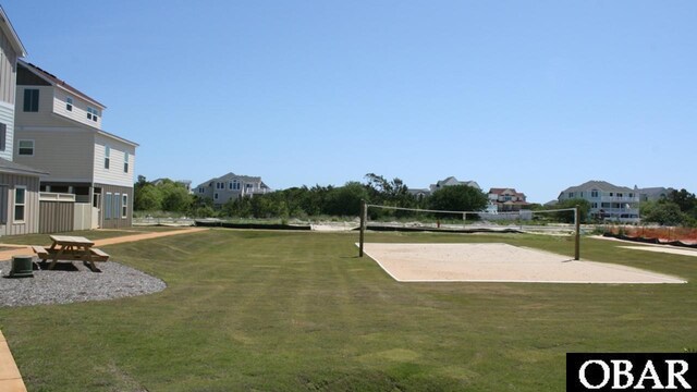 surrounding community featuring a residential view, a lawn, and volleyball court