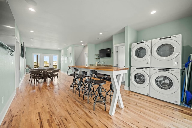 2103 Sandfiddler Rd Lot # 25, Corolla, NC 27927 - washroom featuring stacked washer / dryer, light wood-type flooring, baseboards, washing machine and clothes dryer, and recessed lighting