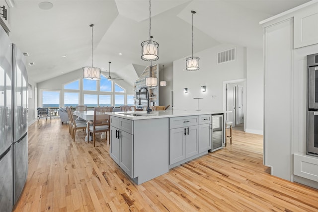 2103 Sandfiddler Rd Lot # 25, Corolla, NC 27927 - kitchen featuring a sink, lofted ceiling, light wood finished floors, a kitchen island with sink, and beverage cooler