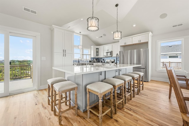 2103 Sandfiddler Rd Lot # 25, Corolla, NC 27927 - kitchen featuring appliances with stainless steel finishes, lofted ceiling, a breakfast bar, light wood finished floors, and recessed lighting