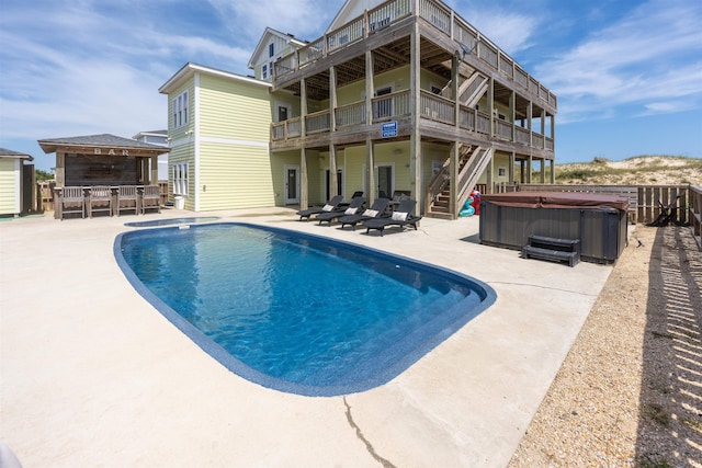 2103 Sandfiddler Rd Lot # 25, Corolla, NC 27927 - swimming pool with a hot tub, a patio area, stairway, and a wooden deck
