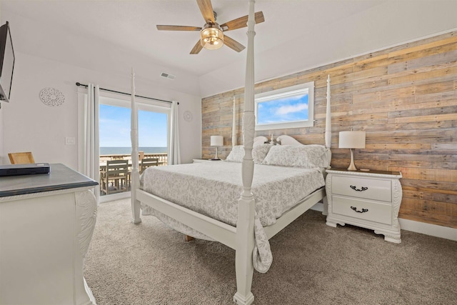 2103 Sandfiddler Rd Lot # 25, Corolla, NC 27927 - carpeted bedroom with access to outside, wooden walls, multiple windows, and ceiling fan