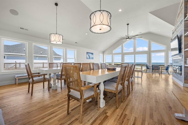2103 Sandfiddler Rd Lot # 25, Corolla, NC 27927 - dining room with a stone fireplace, light wood-style floors, ceiling fan, high vaulted ceiling, and recessed lighting