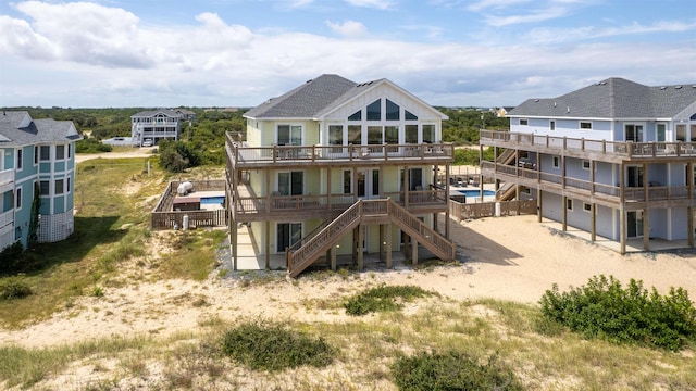 2103 Sandfiddler Rd Lot # 25, Corolla, NC 27927 - back of house featuring a deck, driveway, an outdoor pool, and stairway
