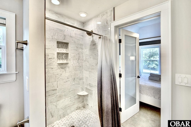 ensuite bathroom with baseboards, ensuite bath, and a shower stall