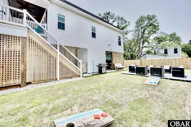 back of property with a patio, fence, a yard, outdoor lounge area, and stairs