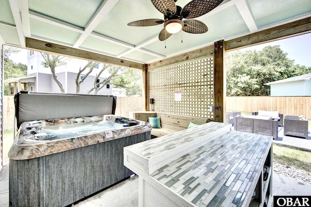 view of patio / terrace with an outdoor hangout area, fence, ceiling fan, and a hot tub