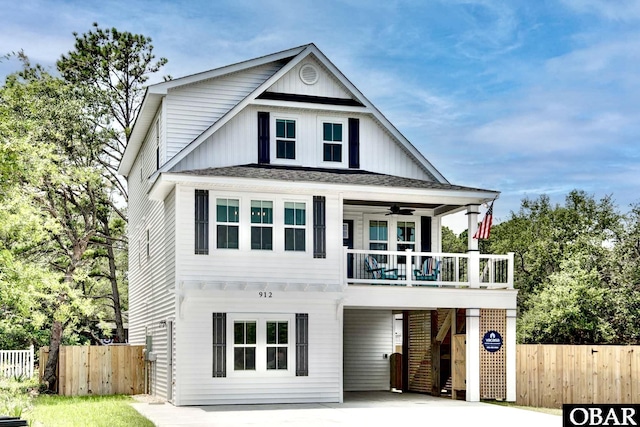 view of front of property with a ceiling fan, fence, stairway, board and batten siding, and a carport