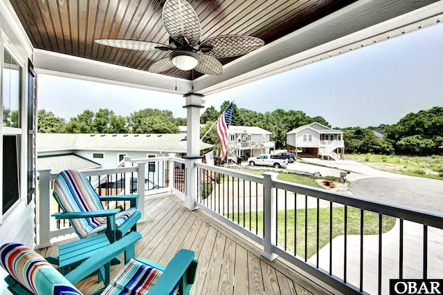 balcony with a residential view and a ceiling fan