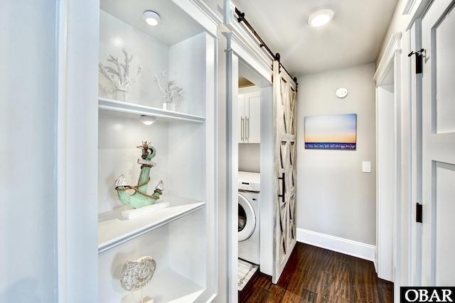 laundry room with baseboards, washer / dryer, cabinet space, dark wood-style flooring, and a barn door