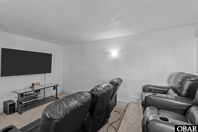 cinema room with light carpet and baseboards