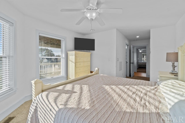 bedroom with ceiling fan, visible vents, and baseboards