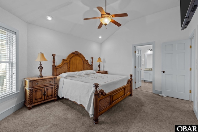 bedroom featuring connected bathroom, carpet flooring, vaulted ceiling, and multiple windows