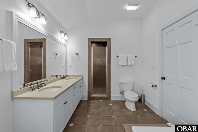 bathroom with a stall shower, tile patterned flooring, a sink, and toilet