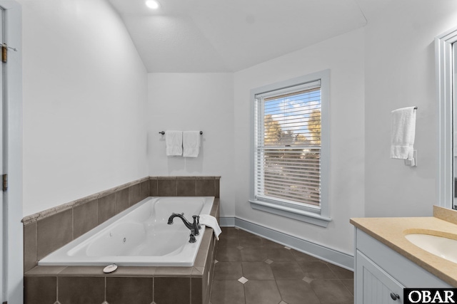 bathroom featuring a whirlpool tub, tile patterned flooring, baseboards, and vanity