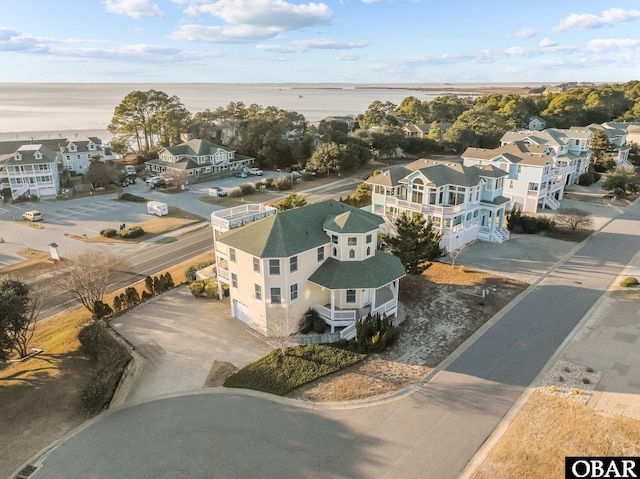 drone / aerial view featuring a water view and a residential view