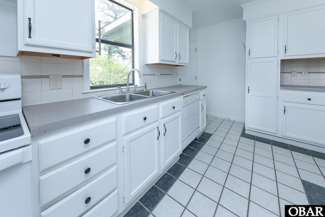 5707 Caratoke Hwy, Poplar Branch, NC 27965 - kitchen with white cabinets, a sink, dishwasher, light countertops, and backsplash