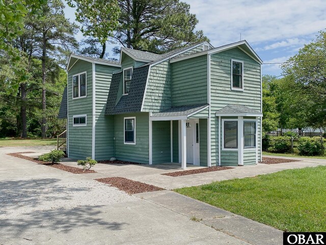 5707 Caratoke Hwy, Poplar Branch, NC 27965 - view of front of home with roof with shingles, driveway, and a gambrel roof