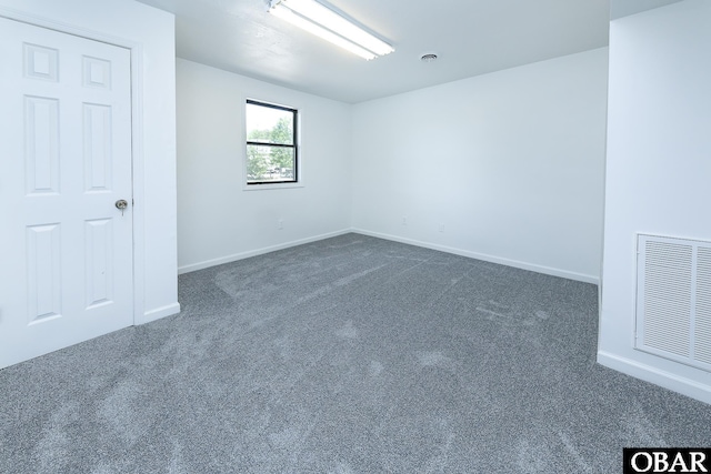 5707 Caratoke Hwy, Poplar Branch, NC 27965 - spare room featuring baseboards, visible vents, and dark carpet