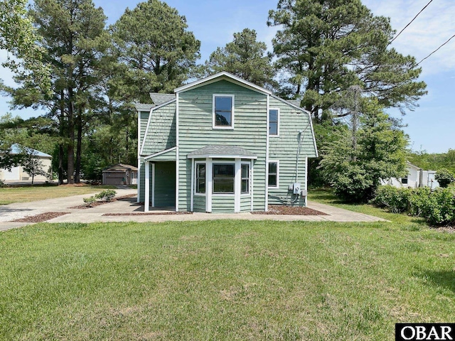 5707 Caratoke Hwy, Poplar Branch, NC 27965 - rear view of property with a lawn and an outdoor structure