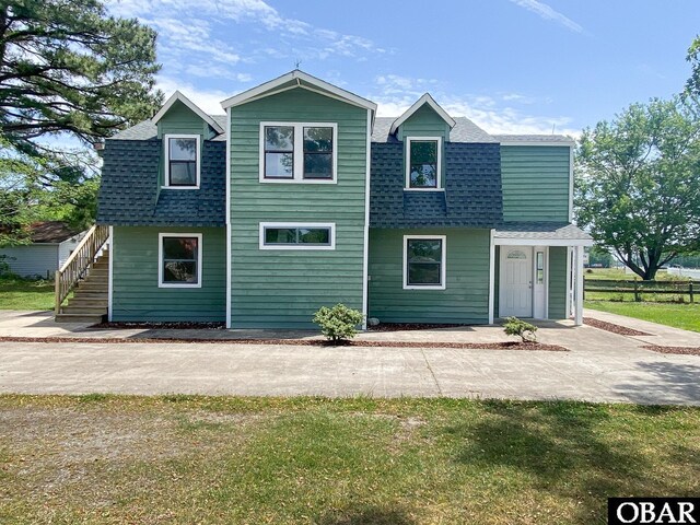 5707 Caratoke Hwy, Poplar Branch, NC 27965 - view of front facade featuring stairs and roof with shingles