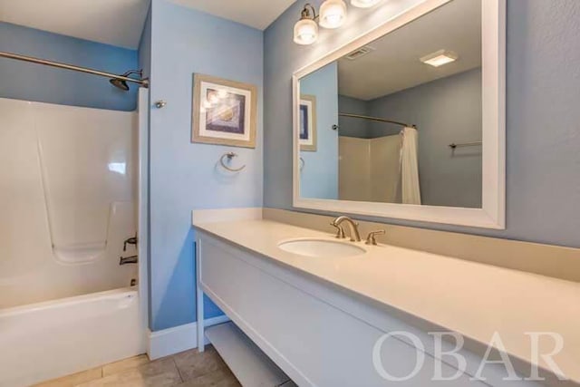 full bathroom featuring shower / bathtub combination with curtain, vanity, baseboards, and tile patterned floors