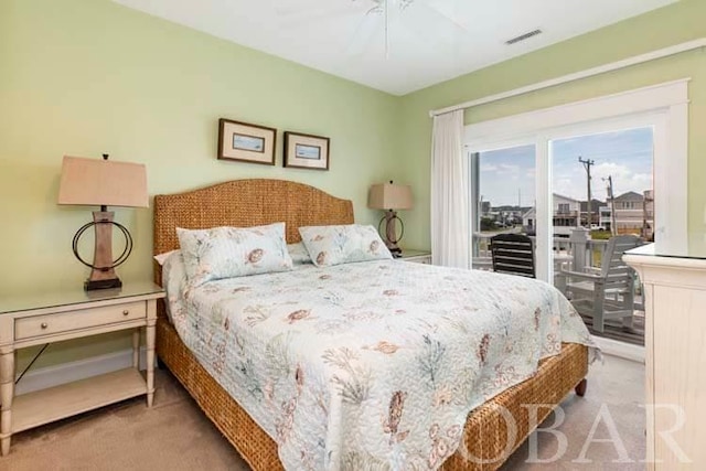 bedroom with access to outside, a ceiling fan, visible vents, and light colored carpet