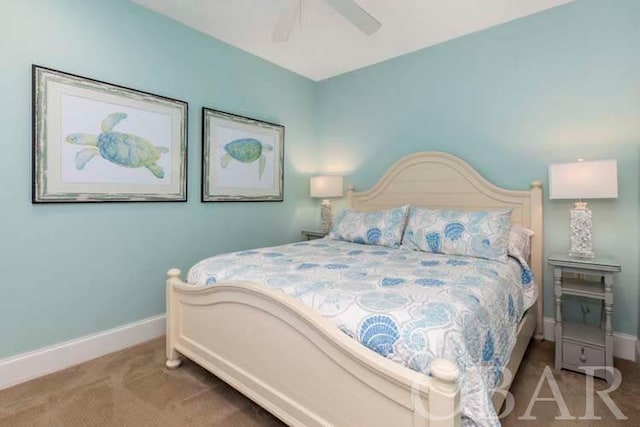 carpeted bedroom with ceiling fan and baseboards