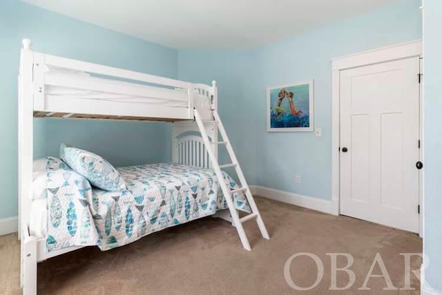 carpeted bedroom featuring baseboards