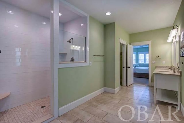 bathroom with recessed lighting, ensuite bath, vanity, baseboards, and walk in shower