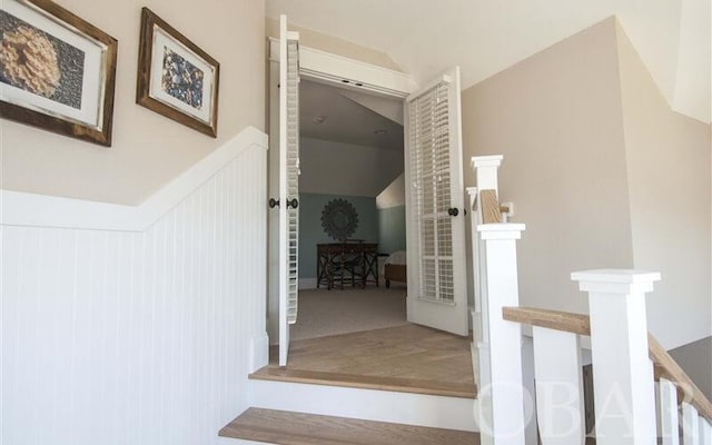 hallway featuring vaulted ceiling