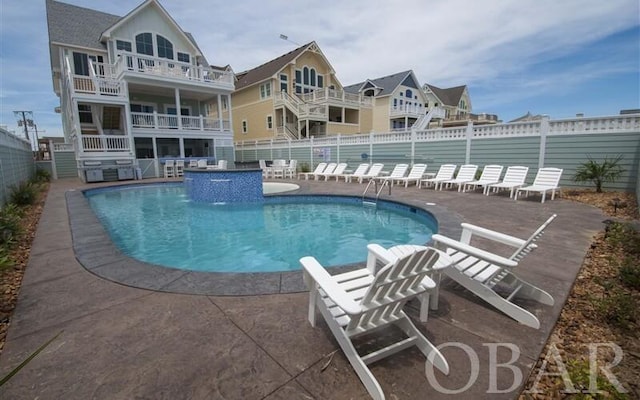 pool featuring a patio area and fence