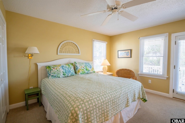 bedroom with baseboards, a textured ceiling, ceiling fan, and carpet flooring