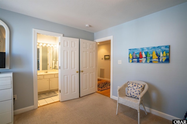 living area featuring visible vents, baseboards, and light colored carpet