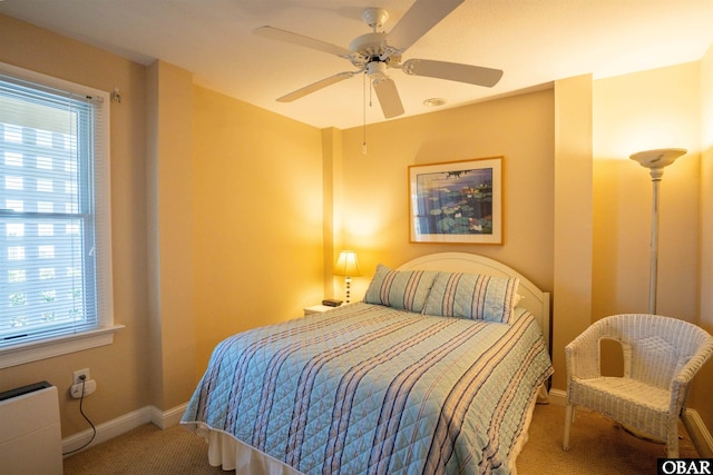 bedroom with baseboards, carpet, and a ceiling fan