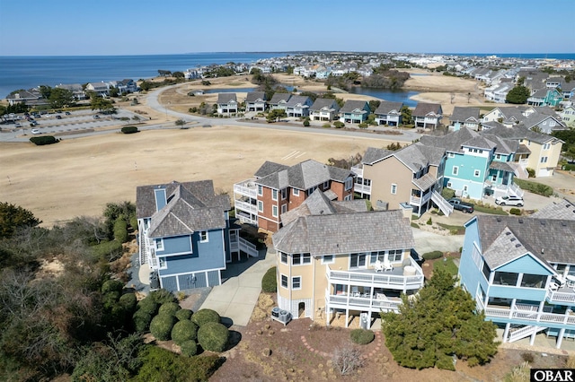 birds eye view of property with a residential view and a water view