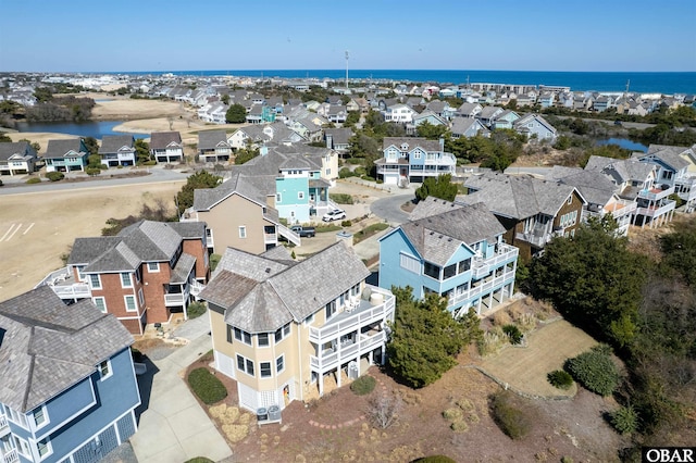 drone / aerial view featuring a residential view and a water view