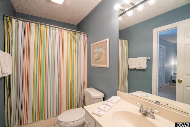 bathroom featuring toilet, vanity, and a textured ceiling