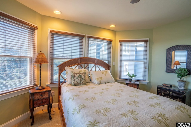 carpeted bedroom featuring recessed lighting, multiple windows, and baseboards