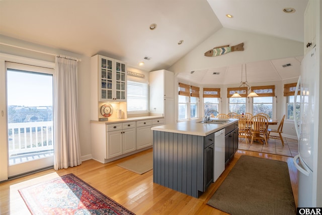 kitchen featuring dishwasher, plenty of natural light, white cabinetry, and a sink