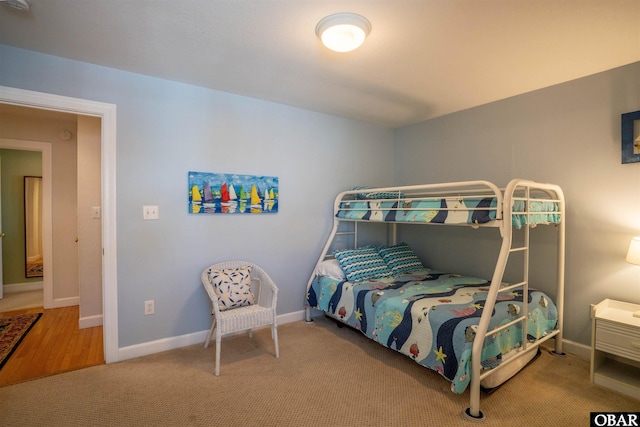 bedroom featuring baseboards and carpet