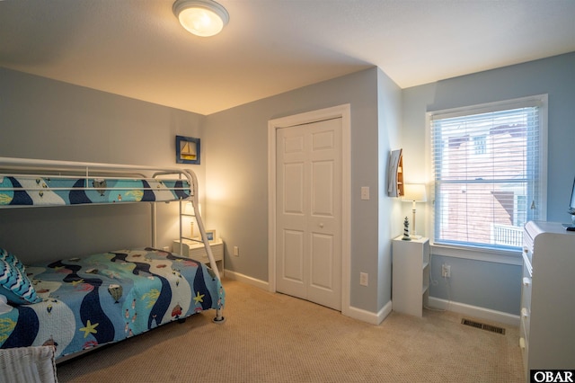 bedroom with visible vents, baseboards, and carpet