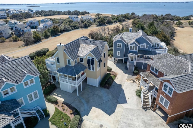 birds eye view of property featuring a residential view and a water view