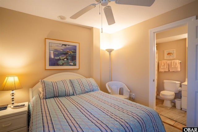 bedroom with tile patterned floors, ensuite bathroom, and ceiling fan